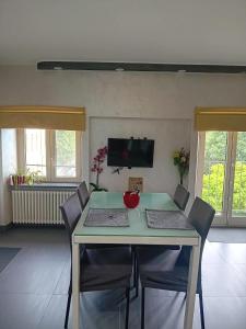 a dining room with a green table and chairs at Monica & Rocco's House in Venaria Reale