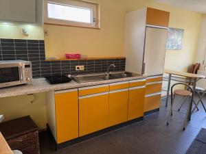 a kitchen with a sink and a microwave at Hotel am Hindenburgplatz in Appenweier +23 photos