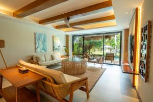 a living room with a couch and a table at Ma'oni Seascape Villas in Panglao Island