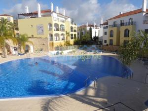 a large swimming pool in front of a building at O Pomar in Cabanas by Wave Algarve in Cabanas de Tavira