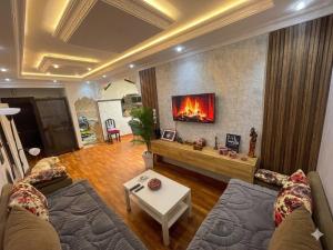 a living room with a couch and a fireplace at dar leena in Essaouira