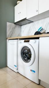 a white washer and dryer in a kitchen at Rona Vista Suites cozy veranda in Polychrono
