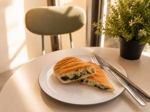 a sandwich on a white plate on a table at CORRIDOR 2407 in Bangkok