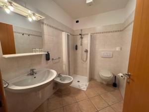 a bathroom with a sink and a toilet at Albergo Lario in Gera Lario +53 photos