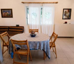 a dining room with a table and chairs at Vicky's Sweet Home - Seaside Retreat in Evia in Agia Anna +10 photos