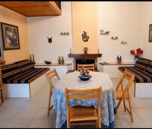 a dining room with a table and chairs and a fireplace at Vicky's Sweet Home - Seaside Retreat in Evia in Agia Anna