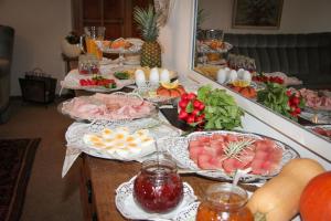 a table with many plates of food on it at Gästehaus Urschel in Bad Kreuznach