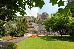 a large building with a mountain in the background at Gästehaus Urschel in Bad Kreuznach