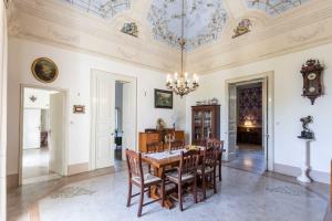 a dining room with a table and chairs and a chandelier at Villa Ciccarese in Cursi
