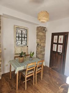a dining room with a wooden table and chairs at Cathedral Suite Jaén in Jaén