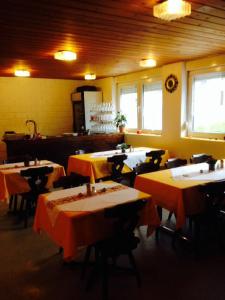 a restaurant with tables and chairs in a room at La Cantina Restaurant in Alvaneu