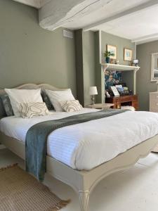 a bedroom with a large bed with white sheets at Le pigeonnier in Le Verdier +16 photos