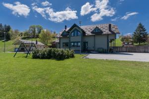 a house with a playground in the yard at Gorski park Kupjak in Kupjak