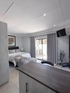 a large bedroom with two beds and a television at Modern & Stylish Bachelor Flat in Burgersdorp