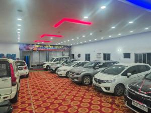 a row of cars parked in a parking lot at Hotel Parinay Vatika in Deoghar