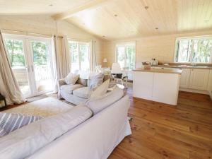a living room with a couch and a kitchen at Skylark in Ross on Wye +10 photos