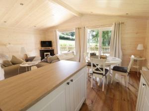 a kitchen and living room with a couch and a table at Skylark in Ross on Wye