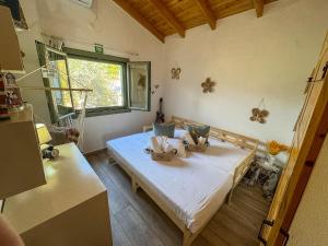 a bedroom with a bed in a room with a window at Elaia Rest House Retreat in nature in Fréngaina +81 photos