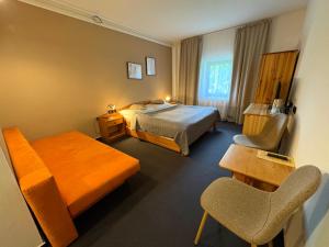 a hotel room with a bed and a chair at Penzion za mlynom in Bešeňová +69 photos