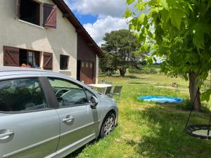 a car parked in a yard next to a house at Chambre in Saint-Pierre-dʼAurillac