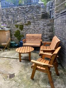 two picnic tables and benches in a patio at lyncrest Tideswell in Buxton