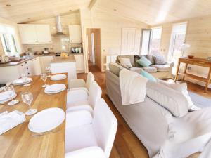 a living room with a couch and a table at Kingfisher in Ross on Wye