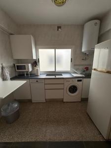 a kitchen with a sink and a washing machine at Brisa azul in Torrenueva