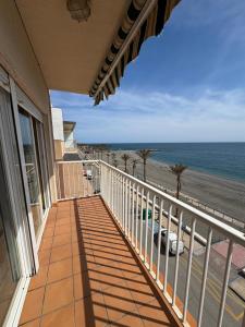 a balcony of a house with a view of the beach at Brisa azul in Torrenueva