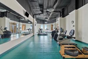 a gym with a row of treadmills and exercise machines at Beach Colony Tower 12B in Perdido Key