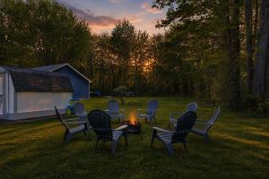 a group of chairs sitting around a fire in a yard at Lake Rd E- Geneva in Geneva