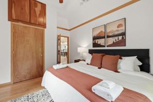 a bedroom with a large white bed with orange pillows at Lake Rd E- Geneva in Geneva