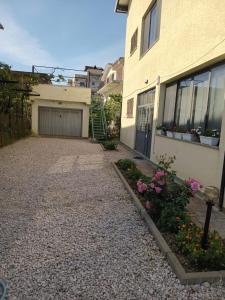 a driveway in front of a house with a garage at EMINI Hotel in Durrës