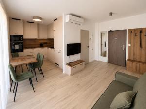 a kitchen and living room with a table and a couch at Rivapark in Dunajská Streda