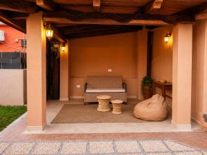 a patio with a chair and a table and a rug at Almarea Apartments in Santa Domenica +19 photos