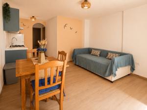 a living room with a table and a couch at Almarea Apartments in Santa Domenica