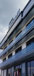 a building with a sign on the top of it at AMARANT hotel in Baysun +5 photos