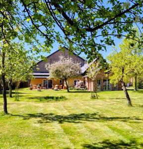 a house with a yard with trees in front of it at Ferienhaus Sükow in Perleberg