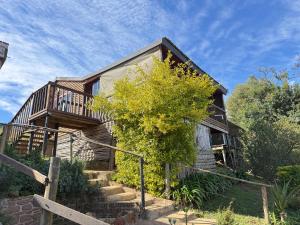 a house with stairs leading up to it at Serendipity Guest Farm Byrne in Byrne