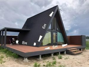 a rendering of a small black house on a beach at Cuyabeno Glamping in Cuyavenus
