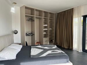 a bedroom with a bed and a book shelf at Vila panorama in Budva