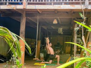 a man is doing a swing in a porch at Berry homestay 1 in Buon Ma Thuot