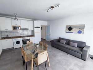 a living room with a couch and a table at RealRent Costa Teguise Beach in Costa Teguise