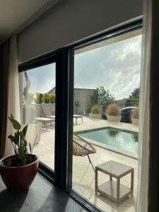 a sliding glass door with a view of a swimming pool at Vila panorama in Budva +41 photos