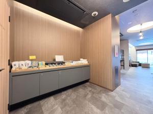 an office lobby with a counter in a room at ALPHABED INN Hakata station front in Fukuoka +54 photos