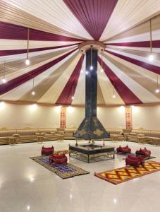a large room with a stage with colorful curtains at WADI RUM TARA lUXURY CAMP in Wadi Rum