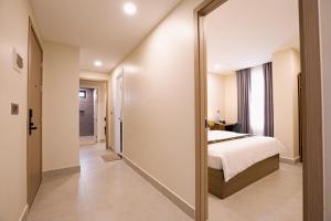 a bedroom with a bed and a large mirror at Walk Street Hotel & Apartment in Phnom Penh +46 photos