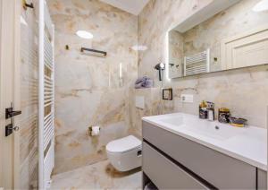 a bathroom with a white sink and a toilet at GemStay Antwerp in Antwerp +41 photos