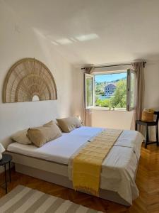 a bedroom with a large bed and a window at Casa Luma in Poljana