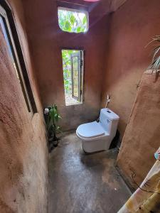 a bathroom with a toilet in a room with a window at Berry homestay 1 in Buon Ma Thuot +64 photos
