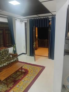 a living room with a couch and a rug at Trailside Homestay in Badulla